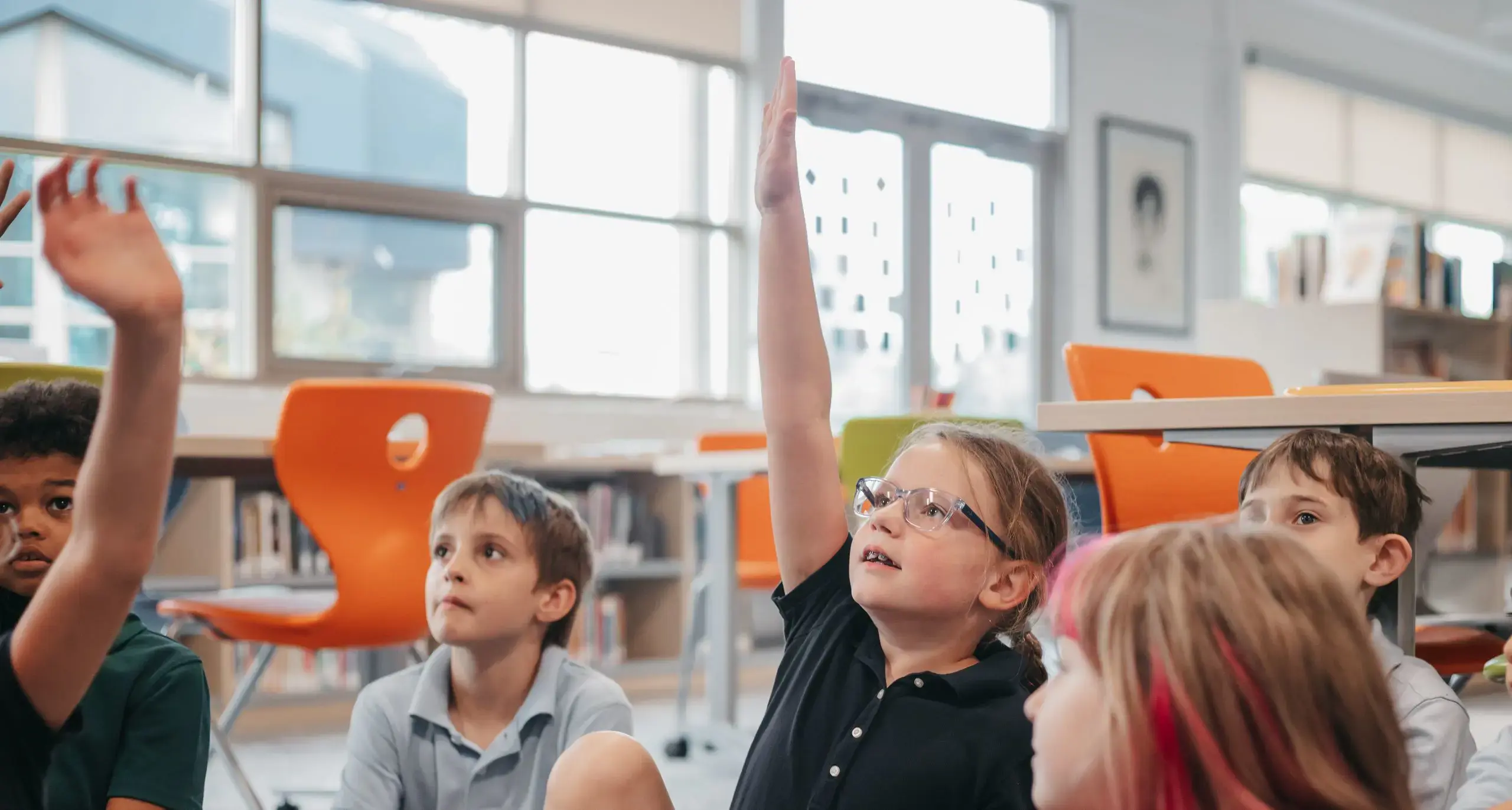 Lower school student raising their hand