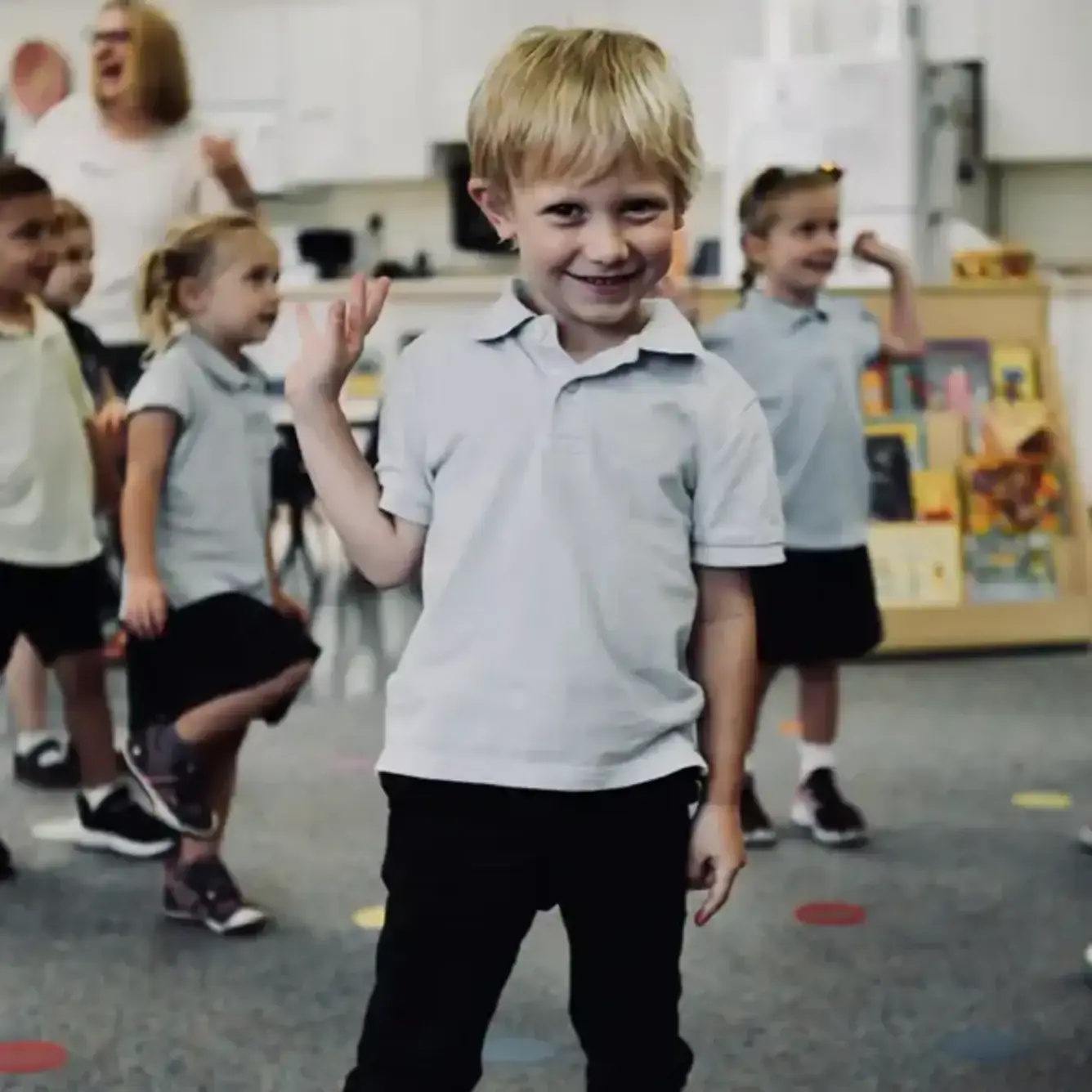 Lower school student waving