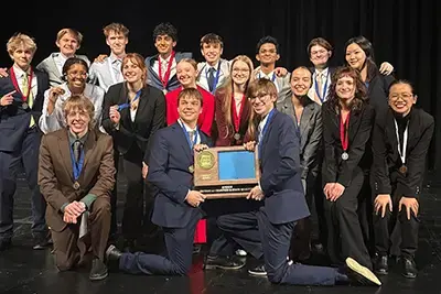 Group of students hoding a trophy