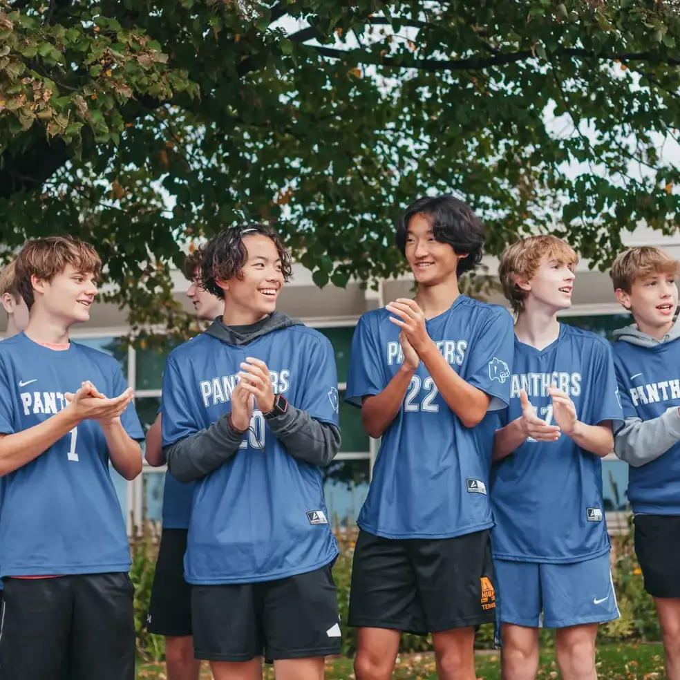 Students cheering together during a school sporting event