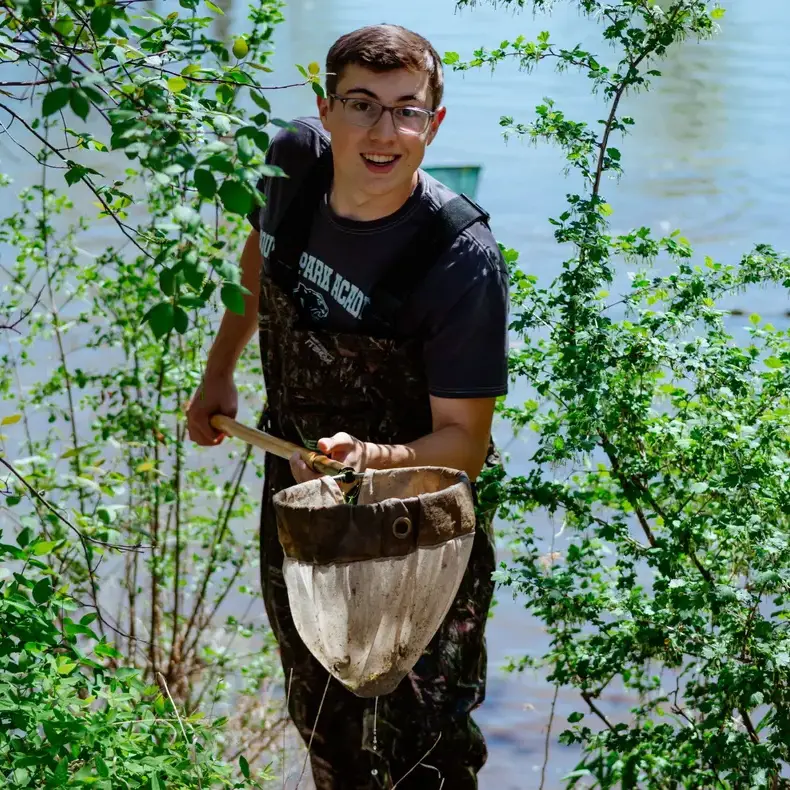 Student collecting samples during outdoor fieldwork