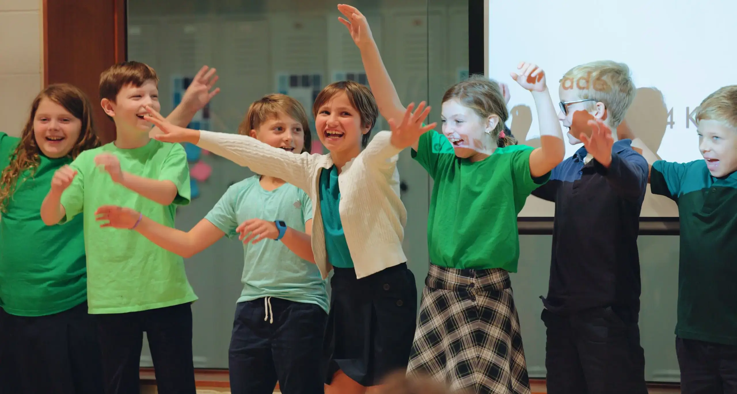 tudents performing together during a school assembly.