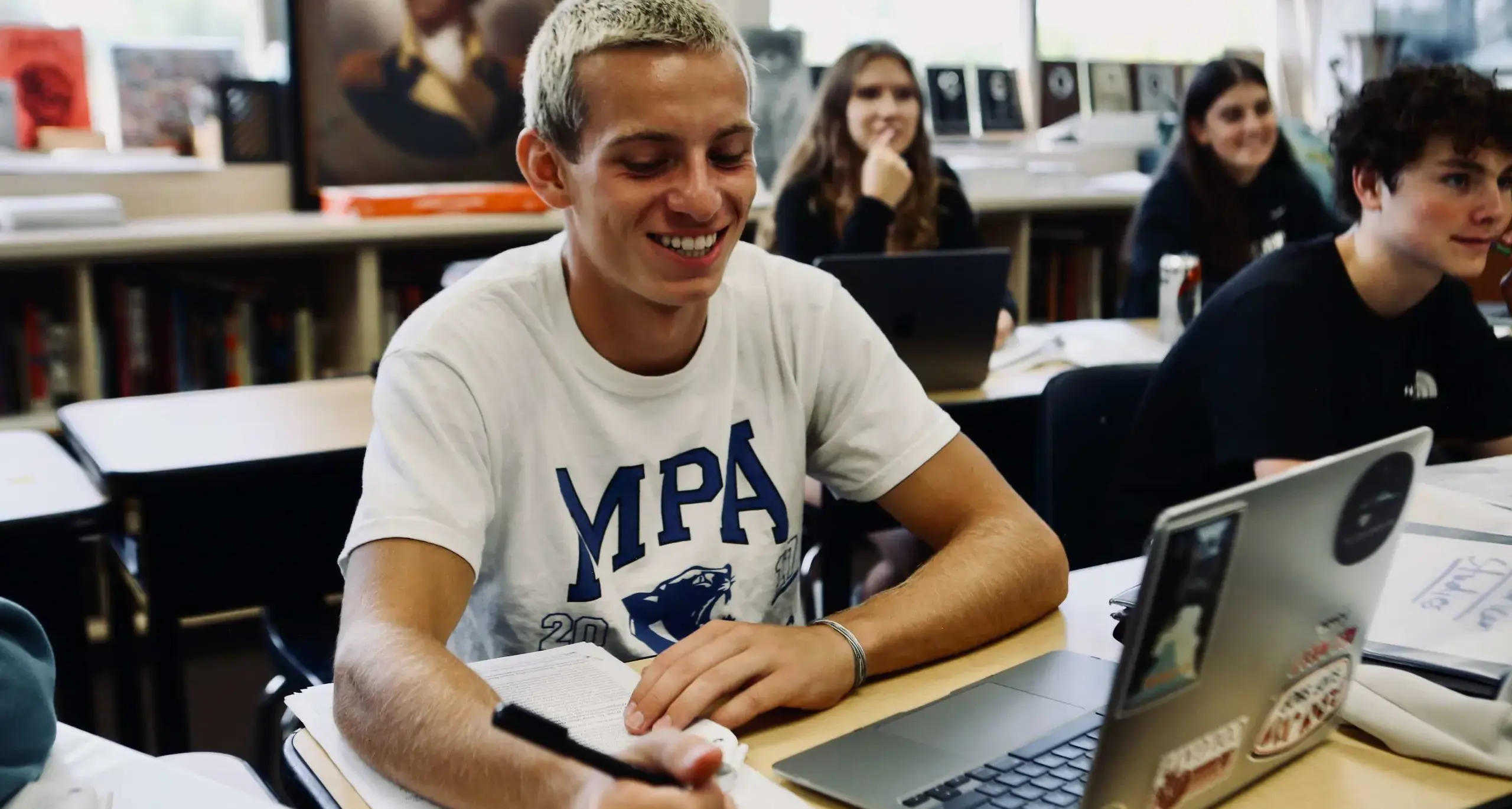High school student working on a laptop in class.