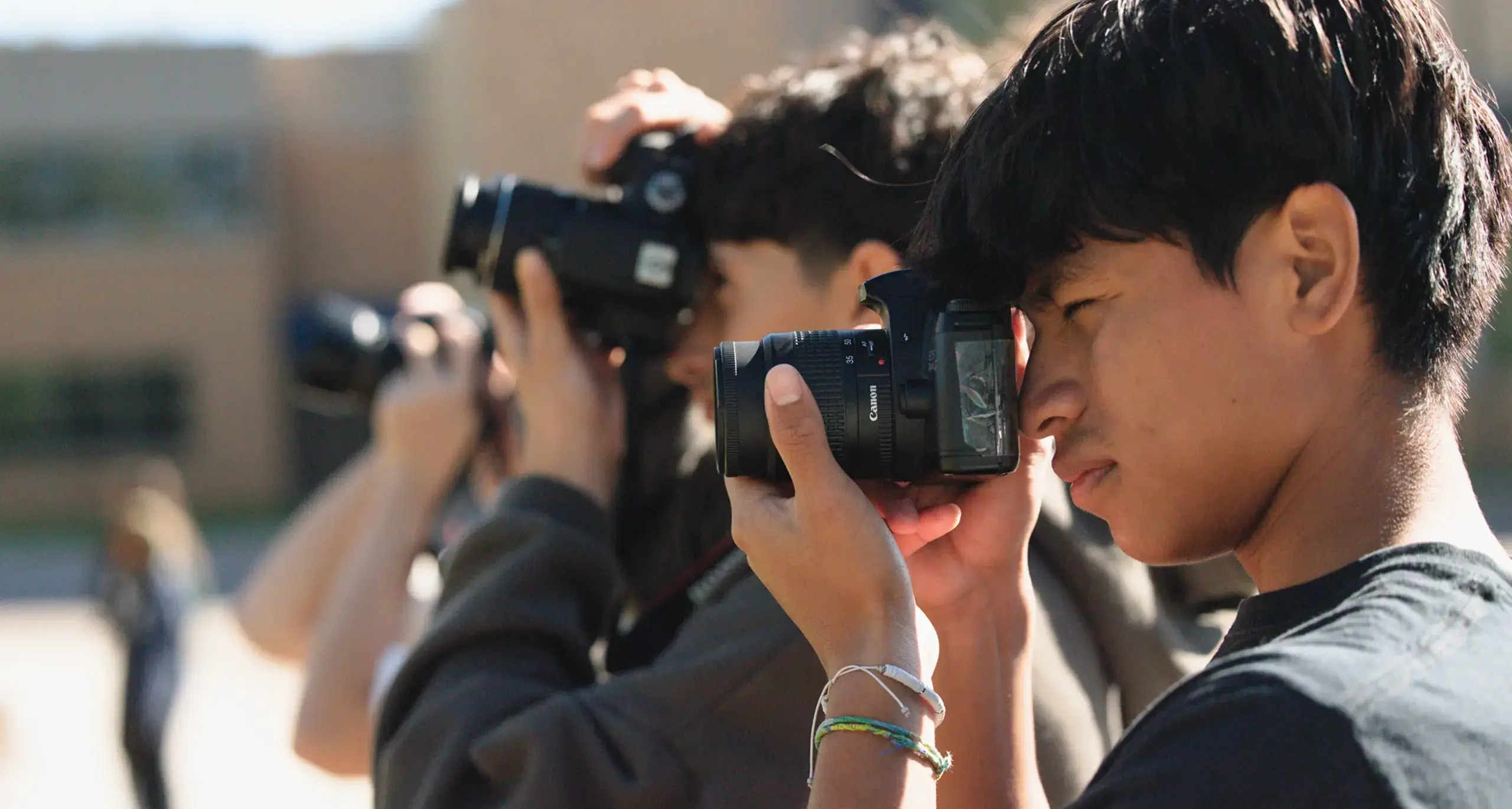 Students taking photographs outdoors