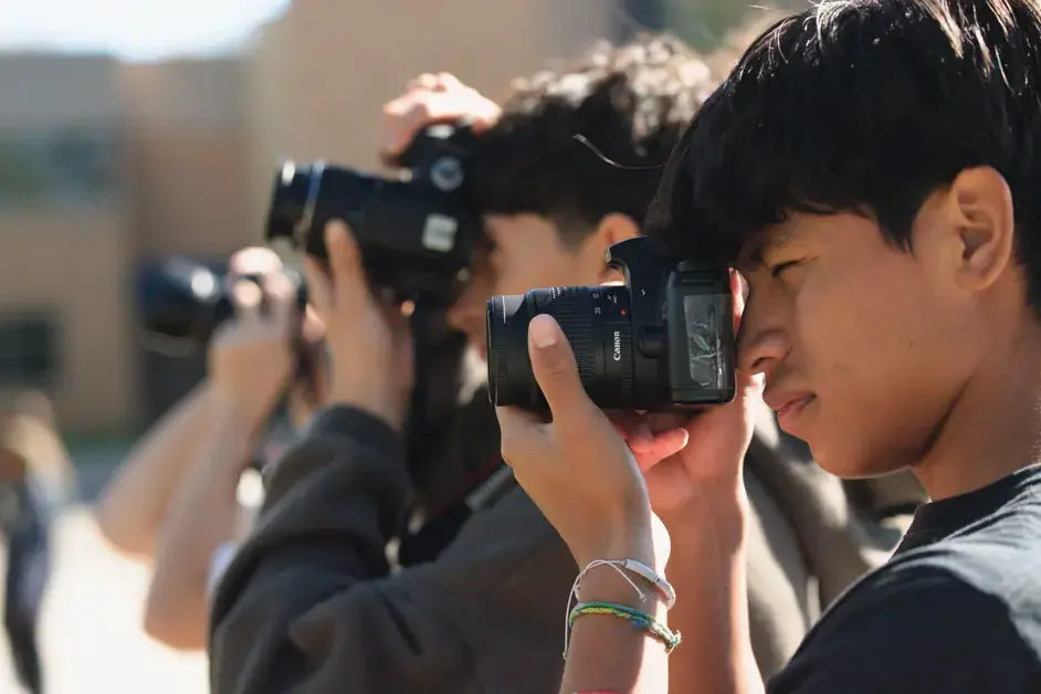 Students taking photographs during a photography lesson.