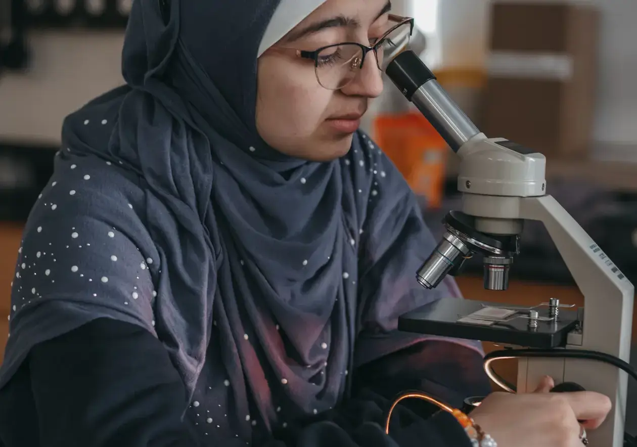 Student looking through a microscope